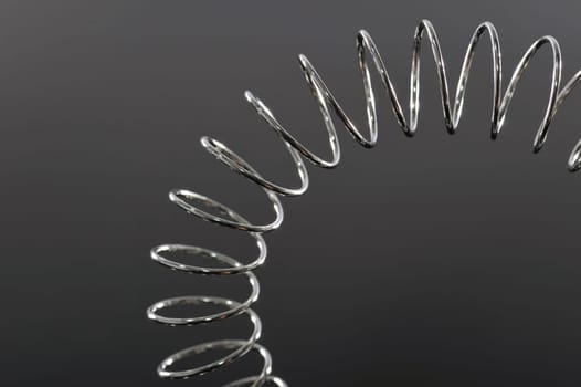 Chrome spiral bent on black background