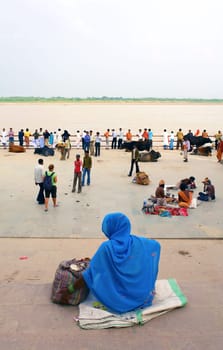 hindu men and women, in square over holy ganges in varanasi, India.