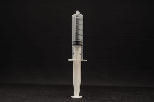 Black and White Syringe on a Dark Background
