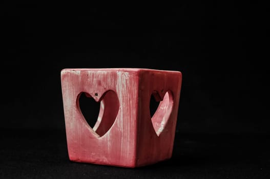 Colorful designed clay vase over a Black background