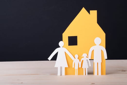 A Yellow House with a White Paper Chain Family
