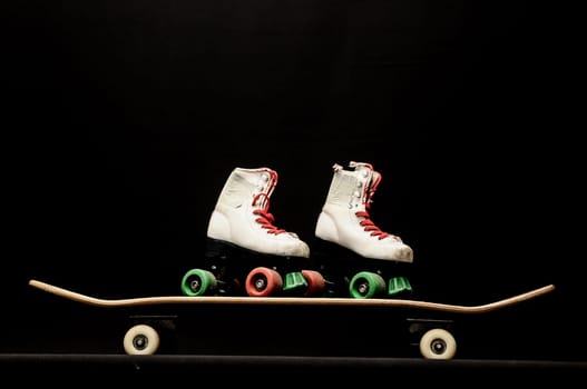 Vintage Style Black Skateboard and Skate Boot on a Dark Background