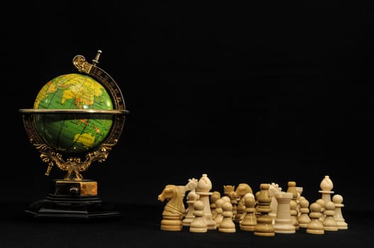 Globe And White Chess on a Black Background