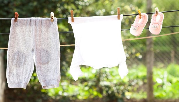 Small Baby clothes hanging on the clothesline