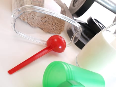 Fitness background with sports equipment and weight gainer