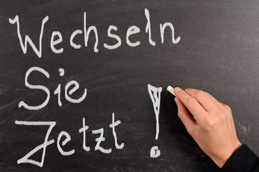 Hand writing with chalk on a blackboard