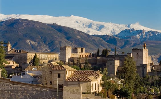 The Alhambra of Granada in Spain with Sierra Nevada snowy mountains as backgorund . Photo taken from the Albaicin, the moorish district of Granada