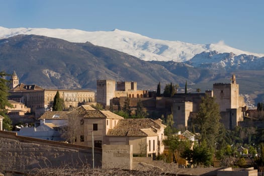 The Alhambra of Granada in Spain with Sierra Nevada snowy mountains as backgorund . Photo taken from the Albaicin, the moorish district of Granada