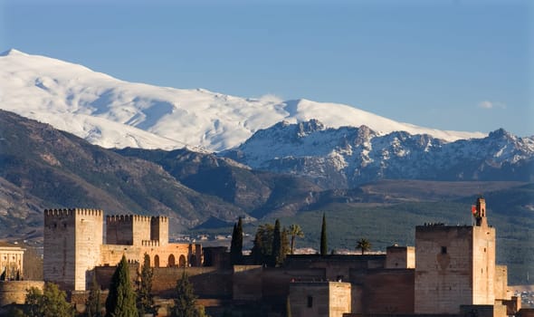 The Alhambra of Granada in Spain with Sierra Nevada snowy mountains as backgorund . Photo taken from the Albaicin, the moorish district of Granada