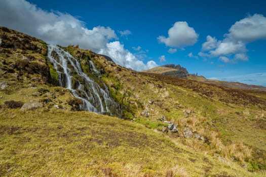 Waterfall with a view of the Old man of storr