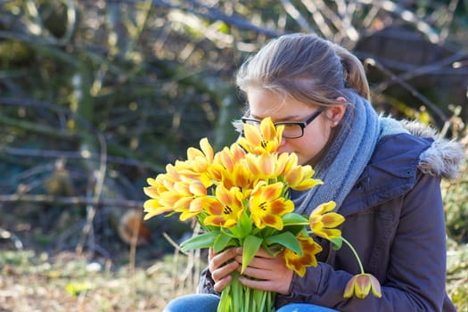 cute young girl with flowers - gift for the mother