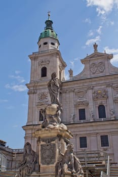 The facade of the Basilica of St. Peter in Salzburg (Austria). Marian column, whose peculiarity is the base of a marble and statue of the lead.