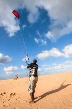 Kite surfing sport action in river lagoon waters and surf action Umdloti river lagoon north of Durban South Africa.