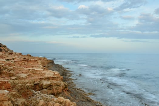 Rocky coast on sunset on a cloudy evening, Costa Blanca, Spain