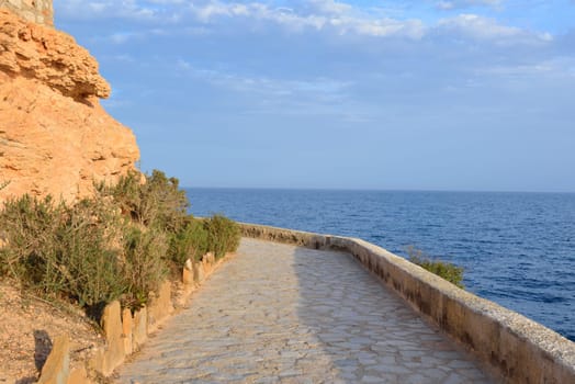 Paved coastal walkway on a summer evening, Cabo Roig, Spain
