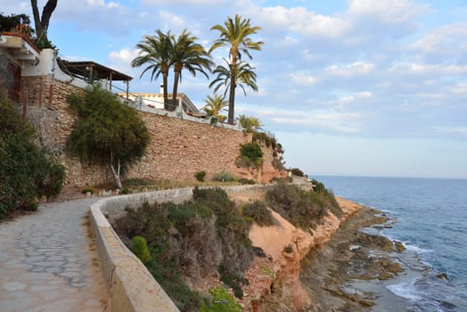 Paved coastal walkway on a summer evening, Cabo Roig, Spain