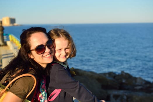 Young woman enjoying a summer evening on the beach with her girl, Costa Blanca, Spain