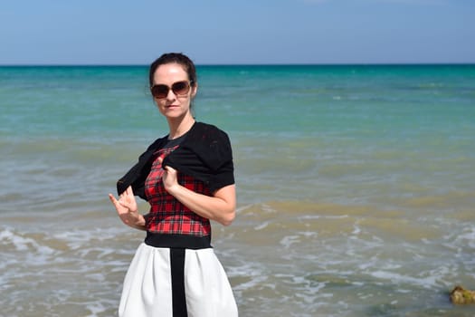 Young woman walking on the beach in a nice summer day, Costa Blanca, Spain