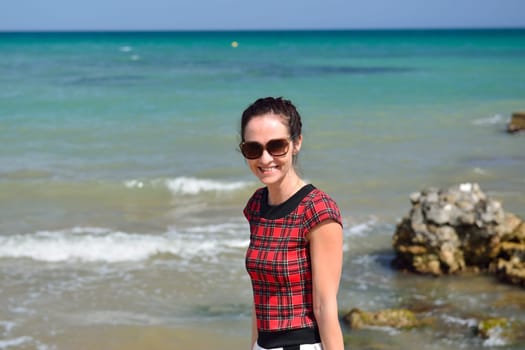 Young woman walking on the beach in a nice summer day, Costa Blanca, Spain