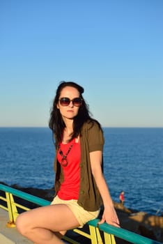 Young woman walking on the beach promenade on a beautiful summer evening, Costa Blanca, Spain