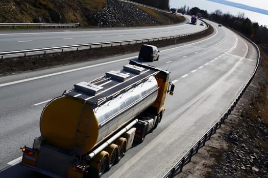 fuel-truck driving on freeway, elevated view from behind
