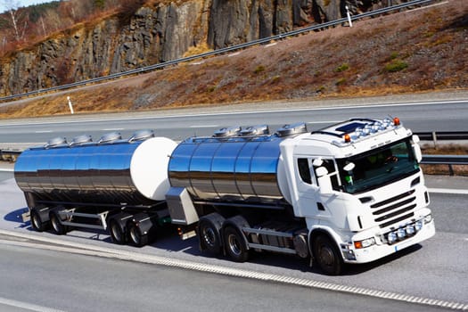 large clean fuel-truck in motion, focal-point on the side of truck.