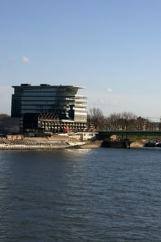 The photograph of a building complex on the Deutzer Bridge with offices and restaurants.