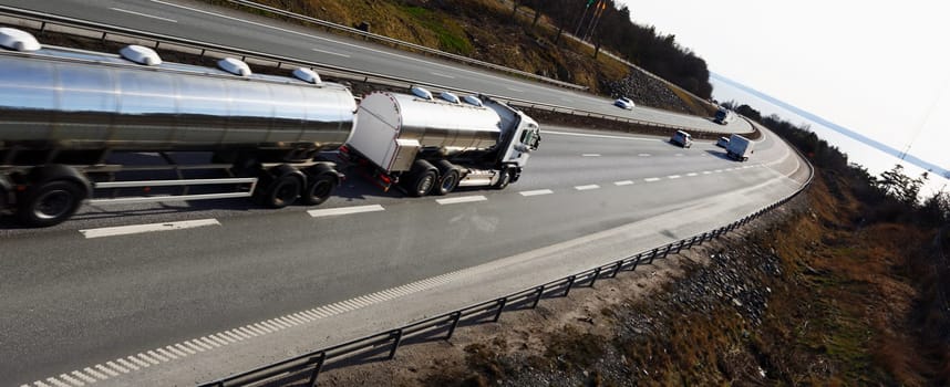 large fuel-truck, slightly blurred in motion, panoramic perspective