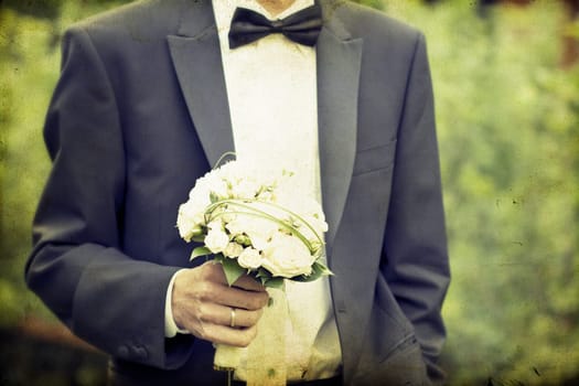 Vintage photo of Groom holding wedding bouquet