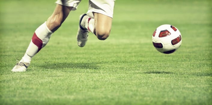 Soccer player running after the ball