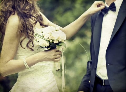 Bride arangeing groom's tie
