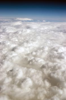 Vertical composition blue sky and fluffy high clouds