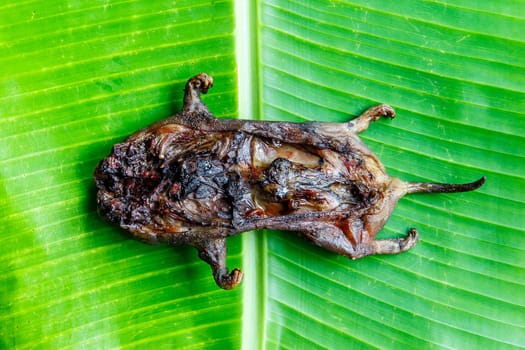 mole grilled for food later on banana leaf