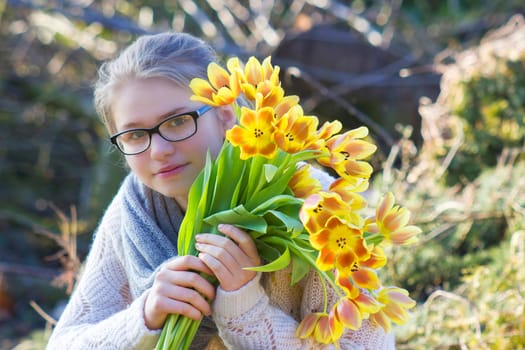 cute young girl with flowers - gift for the mother