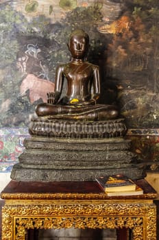 Old Buddha on the table ,with Book of Common Prayer