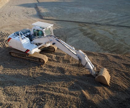 View of white excavator on the construction site