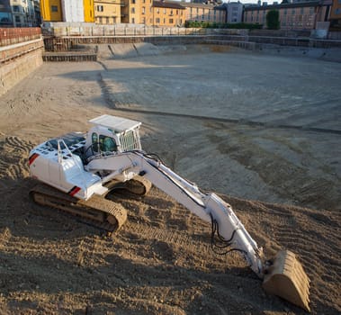 View of white excavator on the construction site