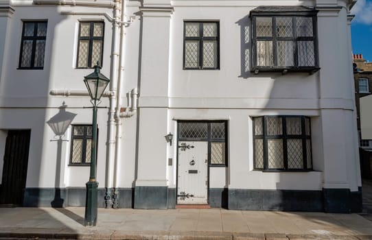 London, UK - Oct 24, 2023 - Facade of a house in De Vere Cottages and street light at South Kensington. Space for text, Selective focus.