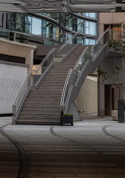 London, UK - Oct 13, 2023 - View of an external modern staircase with stainless steel railing handle grip and glass. Interesting architectural elements, Space for text, Selective focus.
