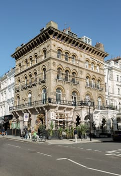London, UK - Oct 24, 2023 - View of Da Mario Kensington an Italian restaurant in the Royal Borough of Kensington. Classic facade of the building decorated with arcs, sculptures, wrought iron fence and other elements. London brick architecture, Space for text, Selective focus.