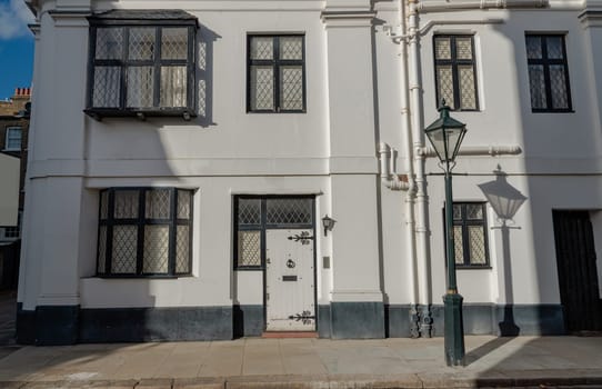 London, UK - Oct 24, 2023 - Facade of a house in De Vere Cottages and street light at South Kensington. Space for text, Selective focus.