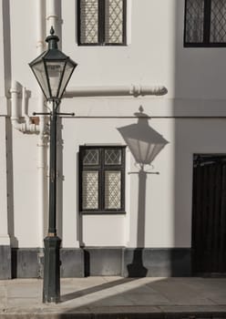 London, UK - Oct 24, 2023 - The shadow of the Street light in front of House in De Vere Cottages at South Kensington. Space for text, Selective focus.
