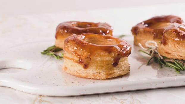 Typical Portuguese pastry Glorias, tender puff pastry topped with handmade caramel candy and special sugar syrup.