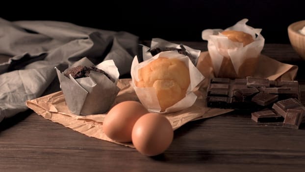 Homemade muffins with chocolate and baking ingredients.