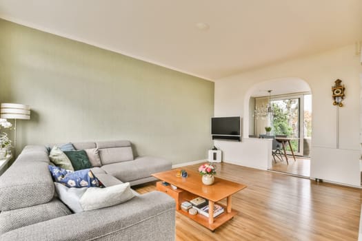 a living room with wood flooring and green wallpaper in the room is very spacious, but it's not too