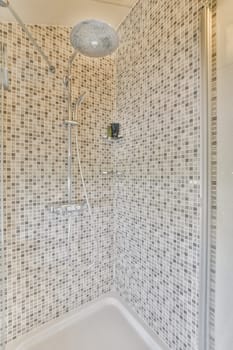 a bathroom with tiled walls and white tiles on the wall, along with a bathtub in the shower stall