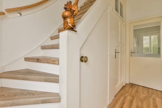 a wooden staircase in a house with white walls and wood flooring the stairs are made from solid planks