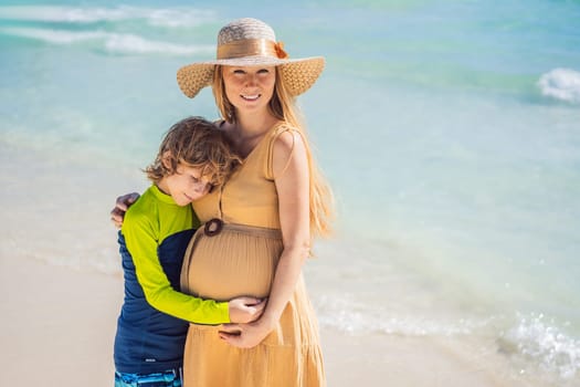 A radiant pregnant mother and her excited son share a tender moment on a serene, snow-white beach, celebrating family love amidst nature's beauty.