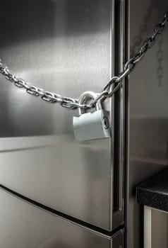 Closeup photo of metal chain on fridge