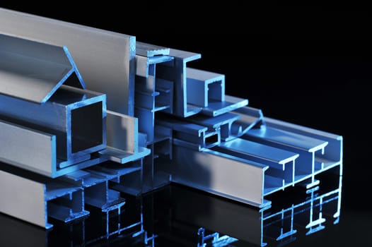 many different aluminium profile strips in blue spotlight